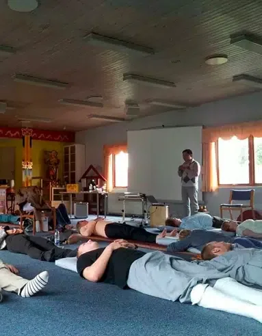 Meditation session in Glostrup, Denmark, with participants lying down to relax